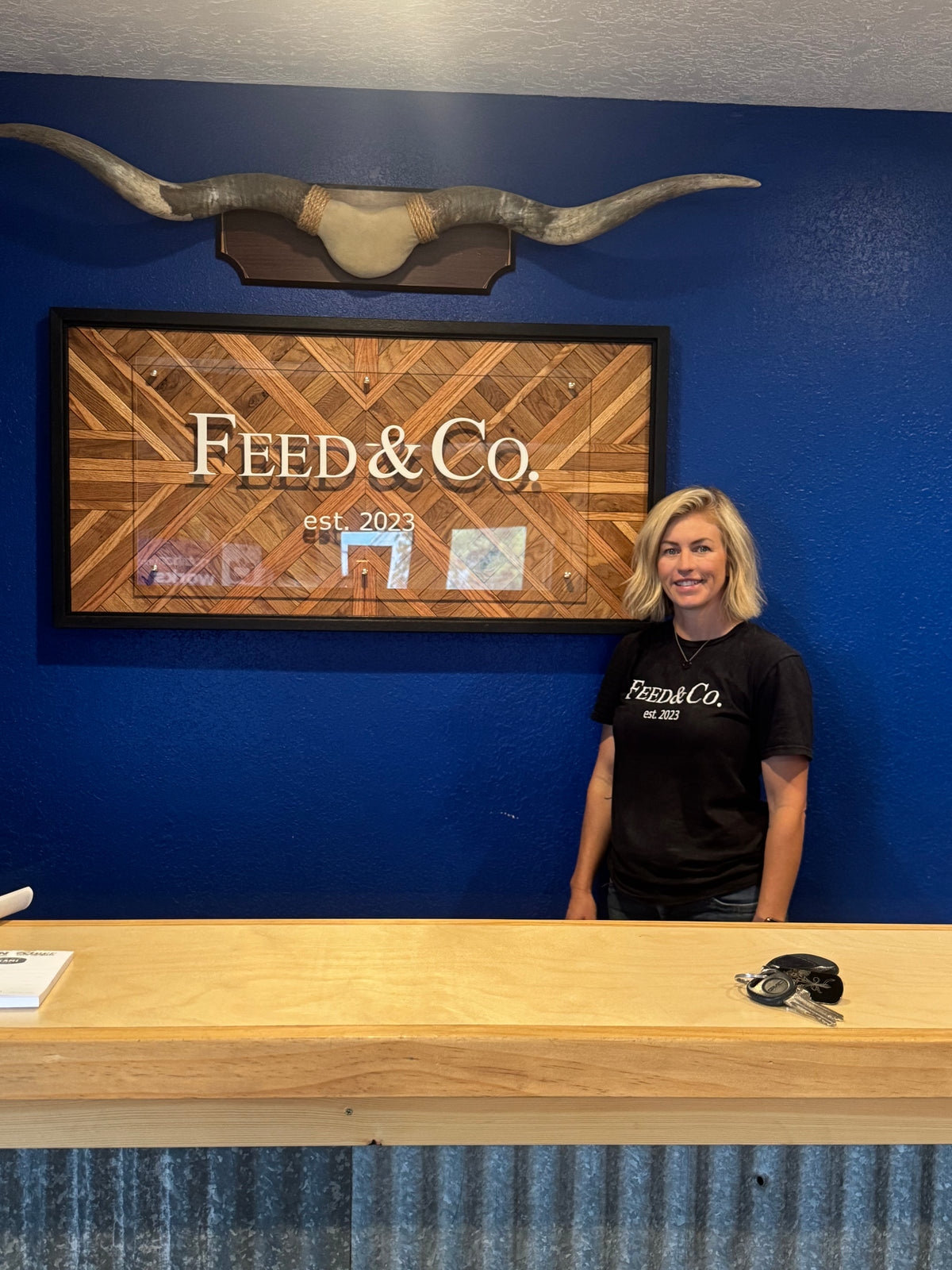 Feed & Co. custom business sign – oak herringbone base with acrylic logo panel