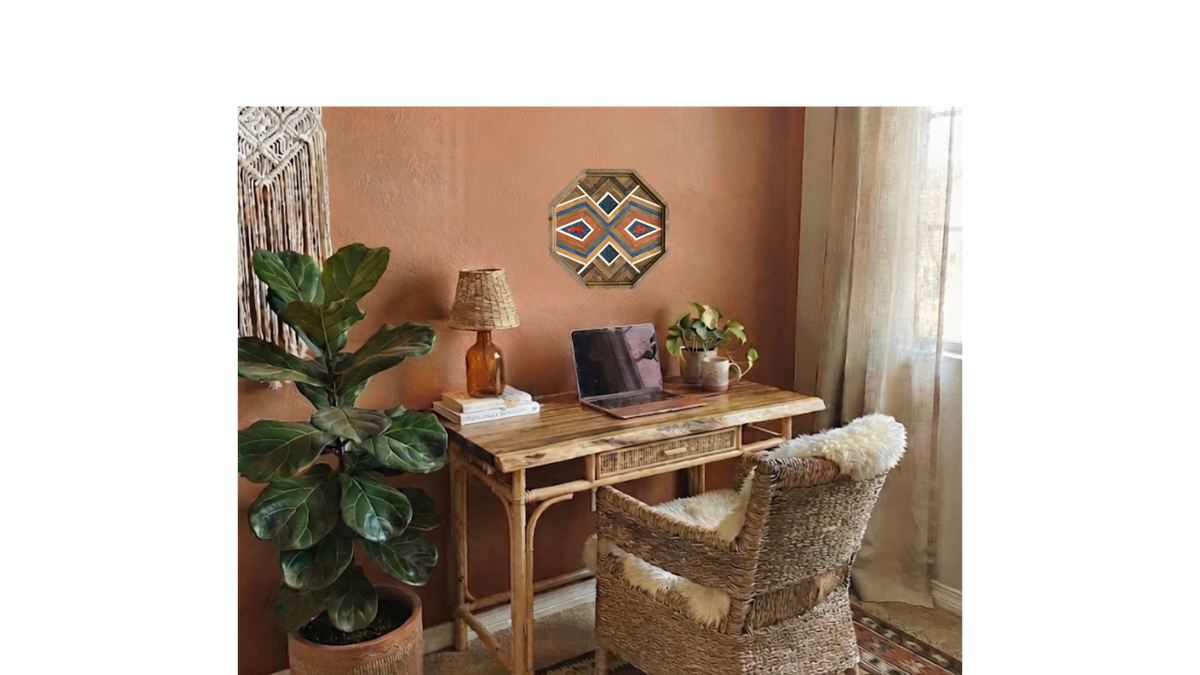 Ember Medallion geometric wood wall art displayed above a boho rattan desk in a warm terracotta office